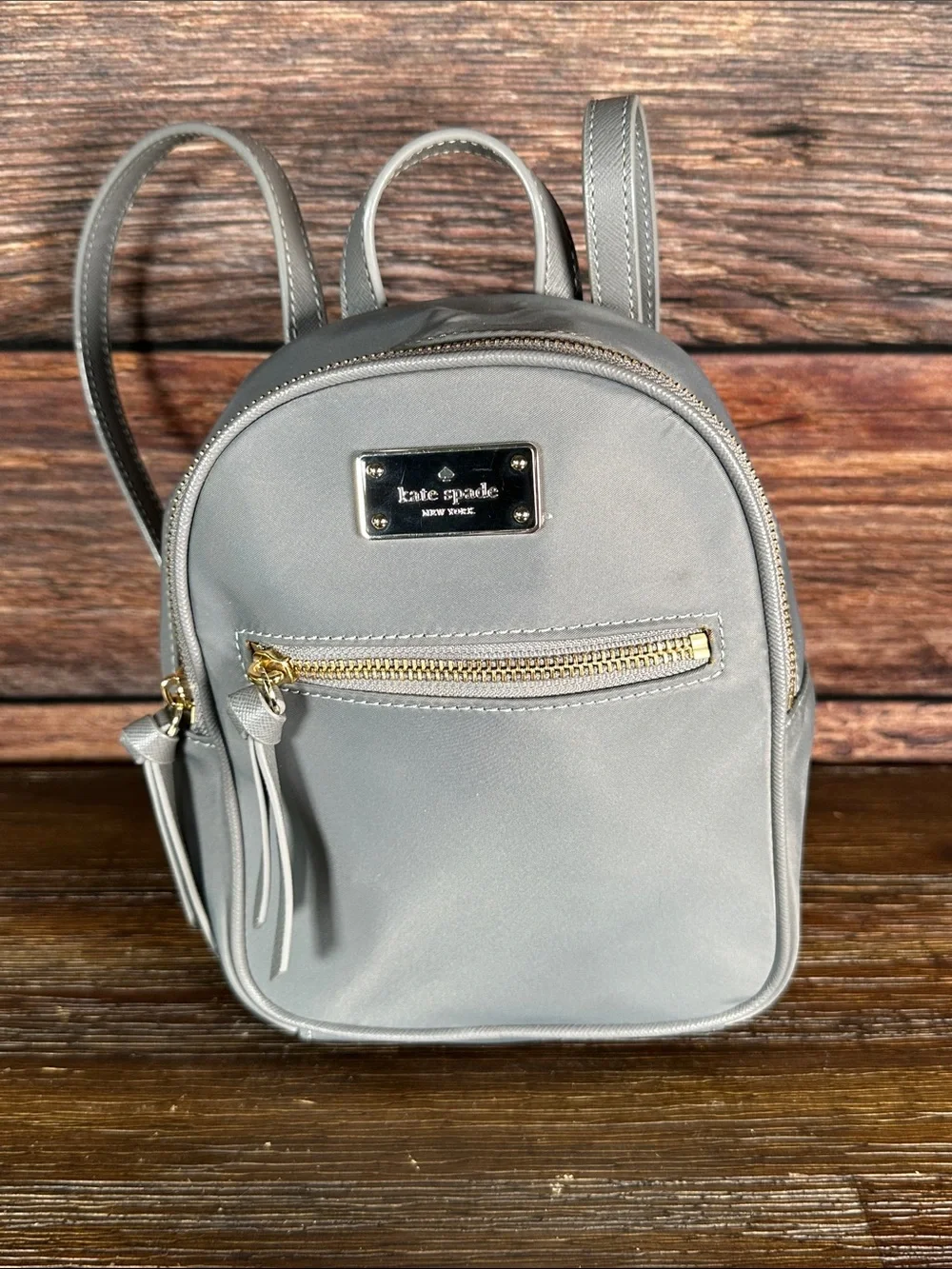 kate spade gray mini Bradley backpack with gold hardware